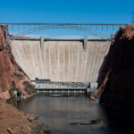 Shown is Glen Canyon Dam as seen from downstream. Glen Canyon Dam is located 15 miles upstream from Lees Ferry on the Colorado River. Glen Canyon Dam is part of the Colorado River Storage Project, CRSP.